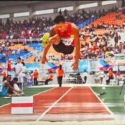 Man in the air before he lands the long jump